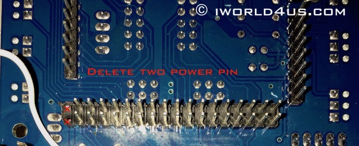 Two 5V power pins marked red for removal on a board